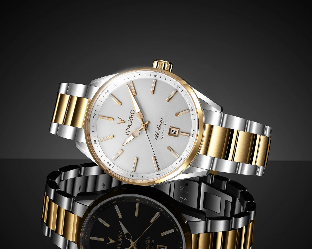 A Vence Calibre 3000 watch with a two-tone silver and gold metal bracelet, a white dial, and a date window, displayed on a reflective dark surface against a black background.
