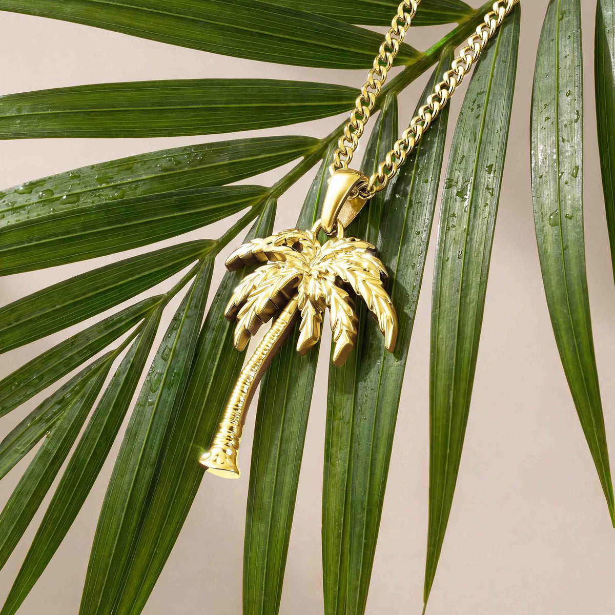 Gold palm tree pendant hanging from a tree 
