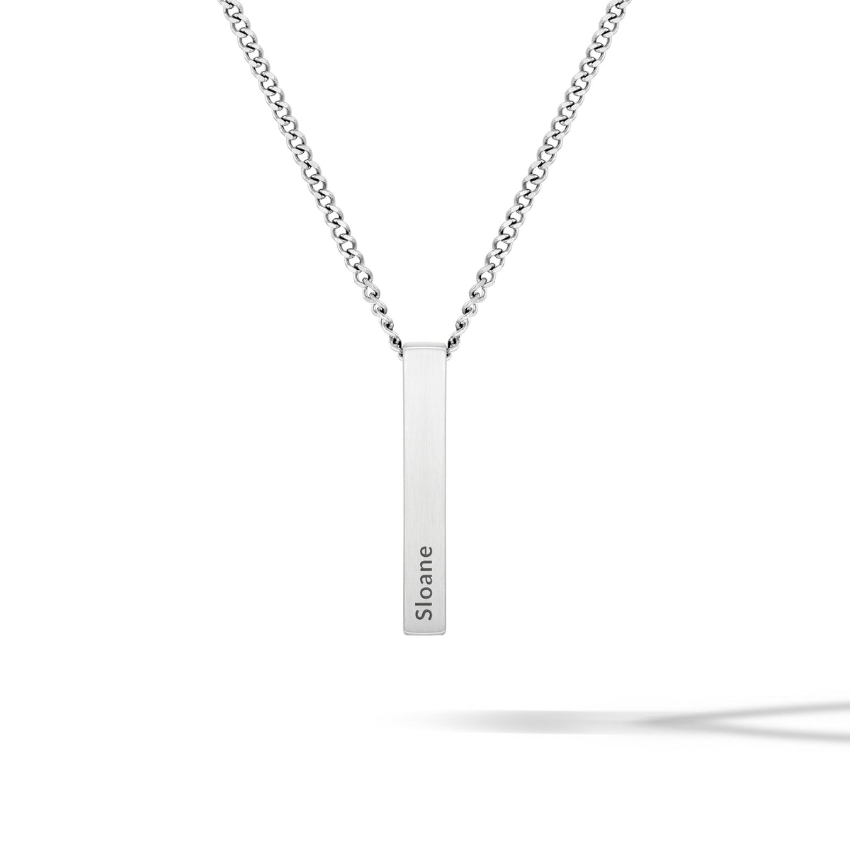 Silver necklace with a bar pendant on a white background