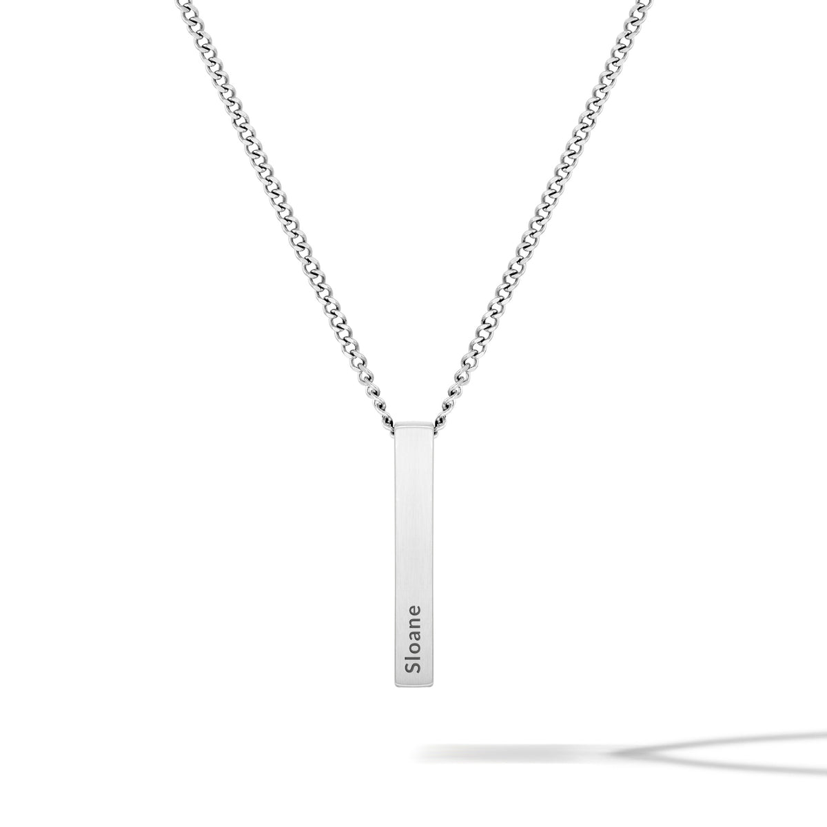 Silver necklace with a bar pendant on a white background