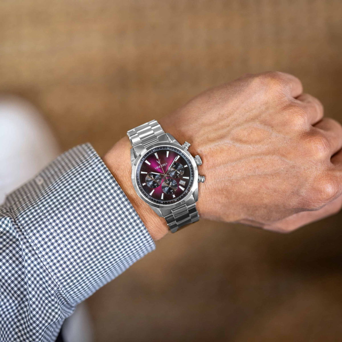 Silver watch on a person's wrist with a blurred background