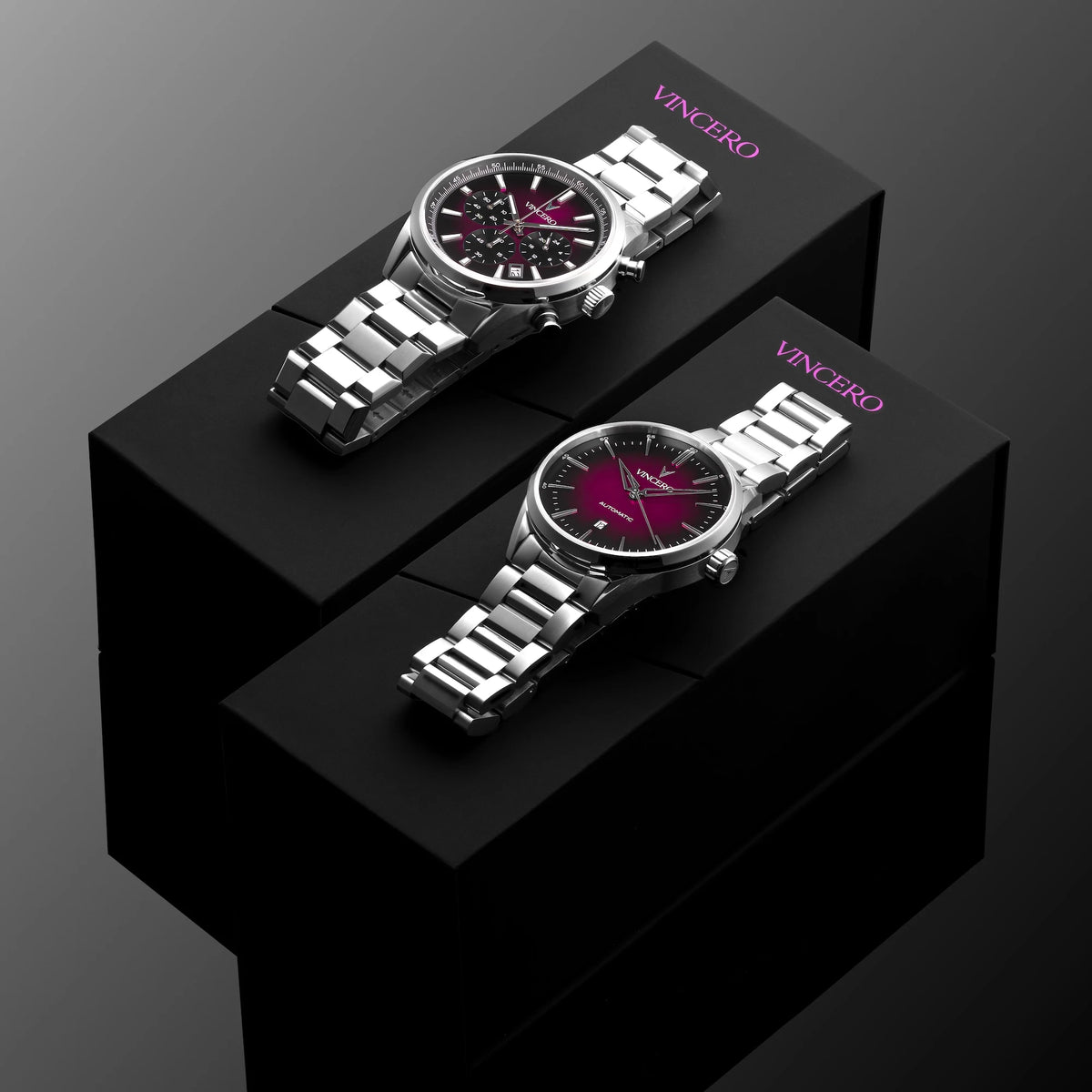 Two silver watches on black stands with 'Vincero' branding against a dark background