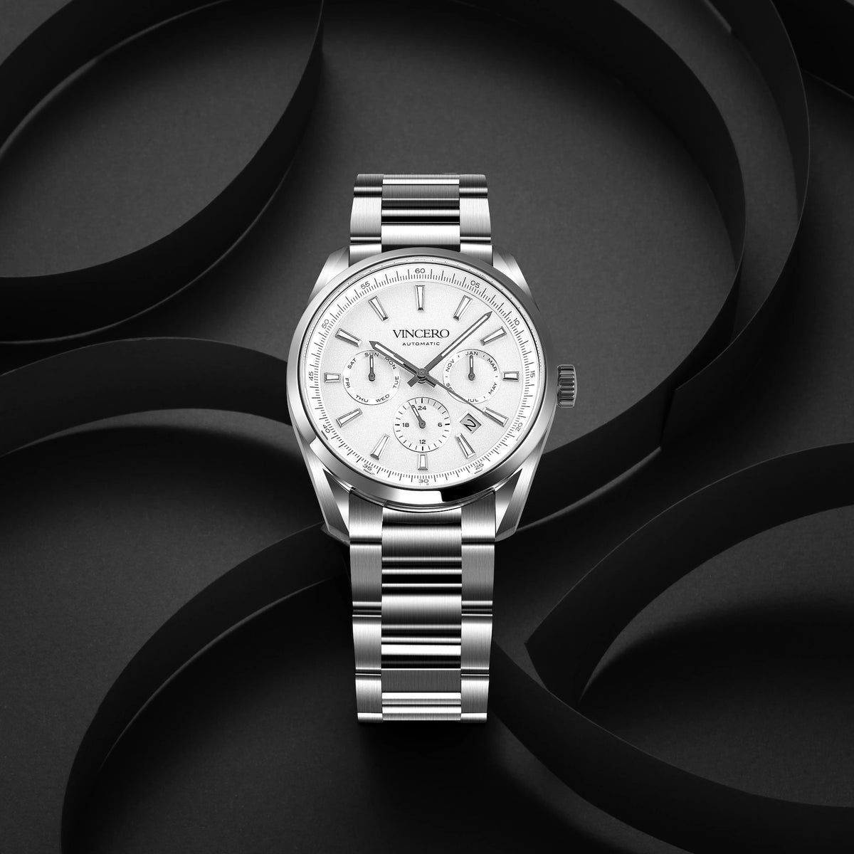 Silver wristwatch with a white face on a black background