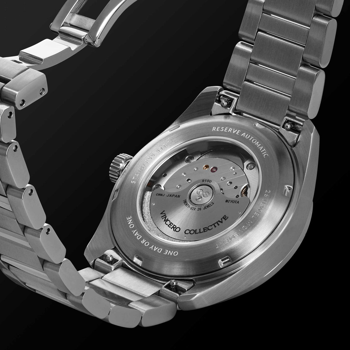 Silver watch with open case displaying mechanical components on a black background