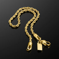 Gold rope chain necklace with clasp on a black background