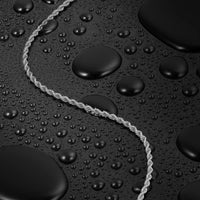 Silver rope necklace on a textured black surface with water droplets