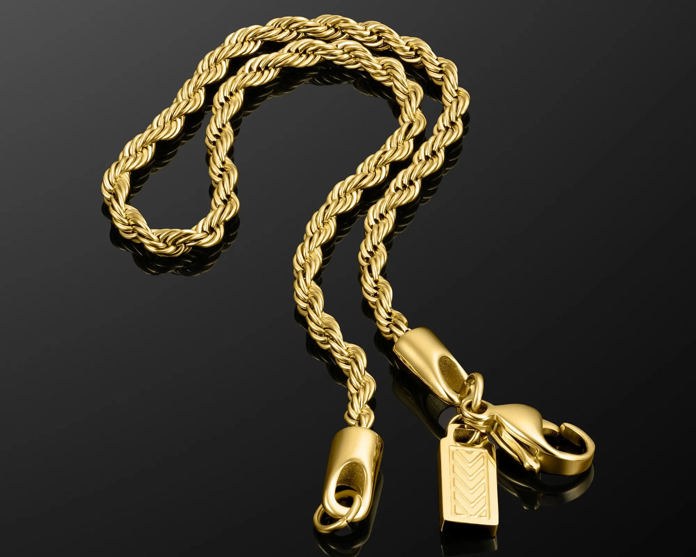 Gold rope chain necklace with clasp on a black background