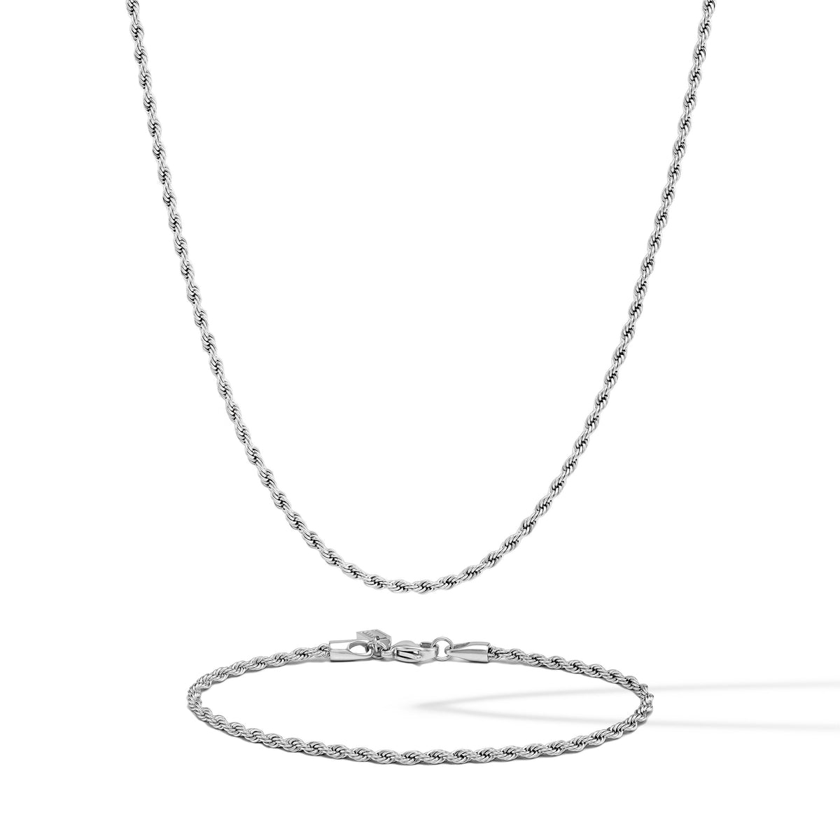 Silver chain necklace and bracelet on a white background