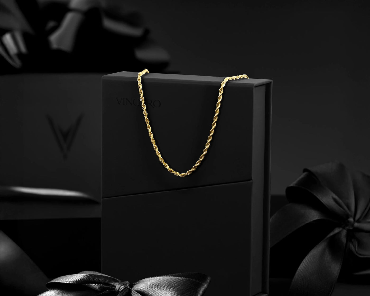 Gold chain on a black box with a dark background