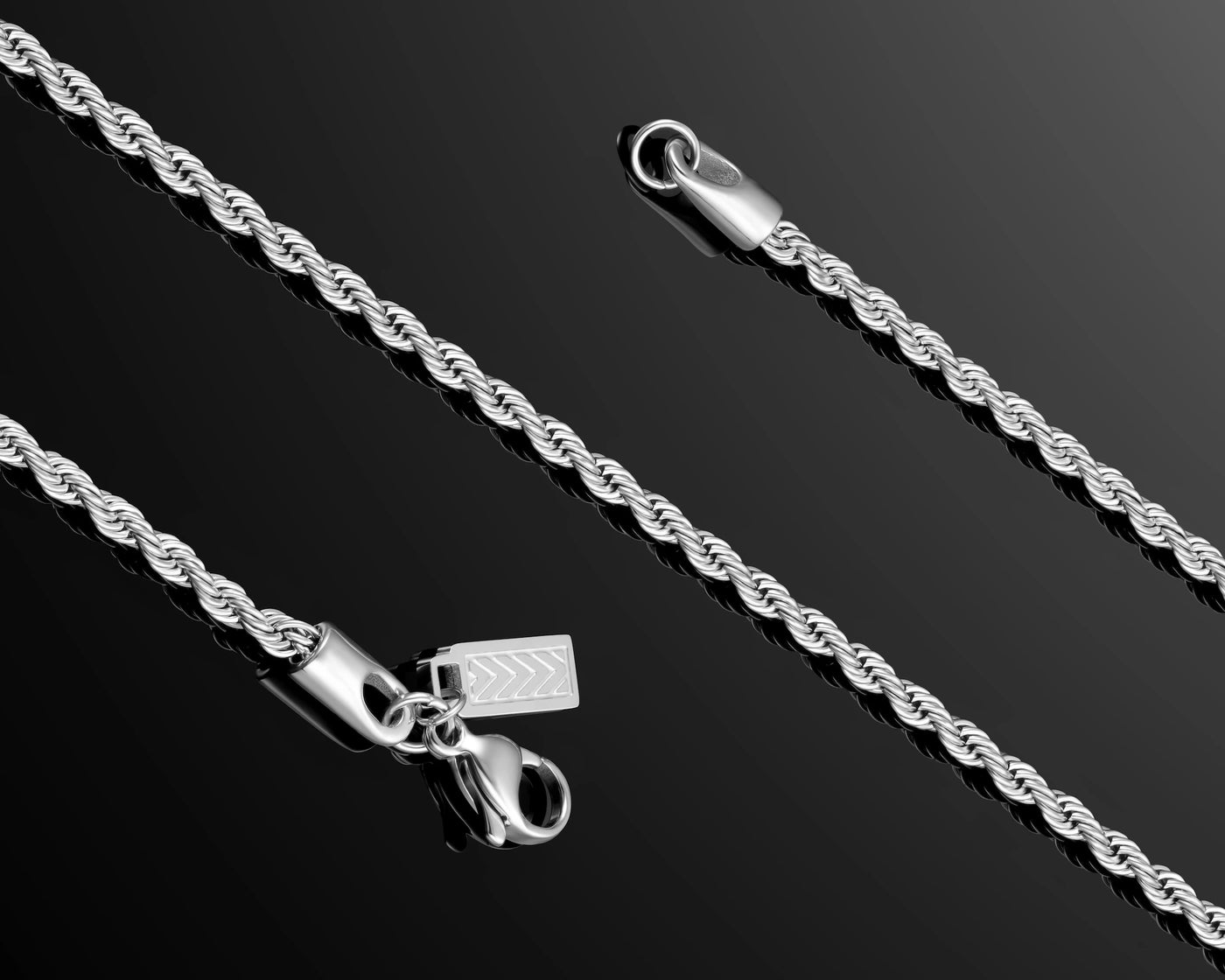 Silver rope chain necklace on a black background