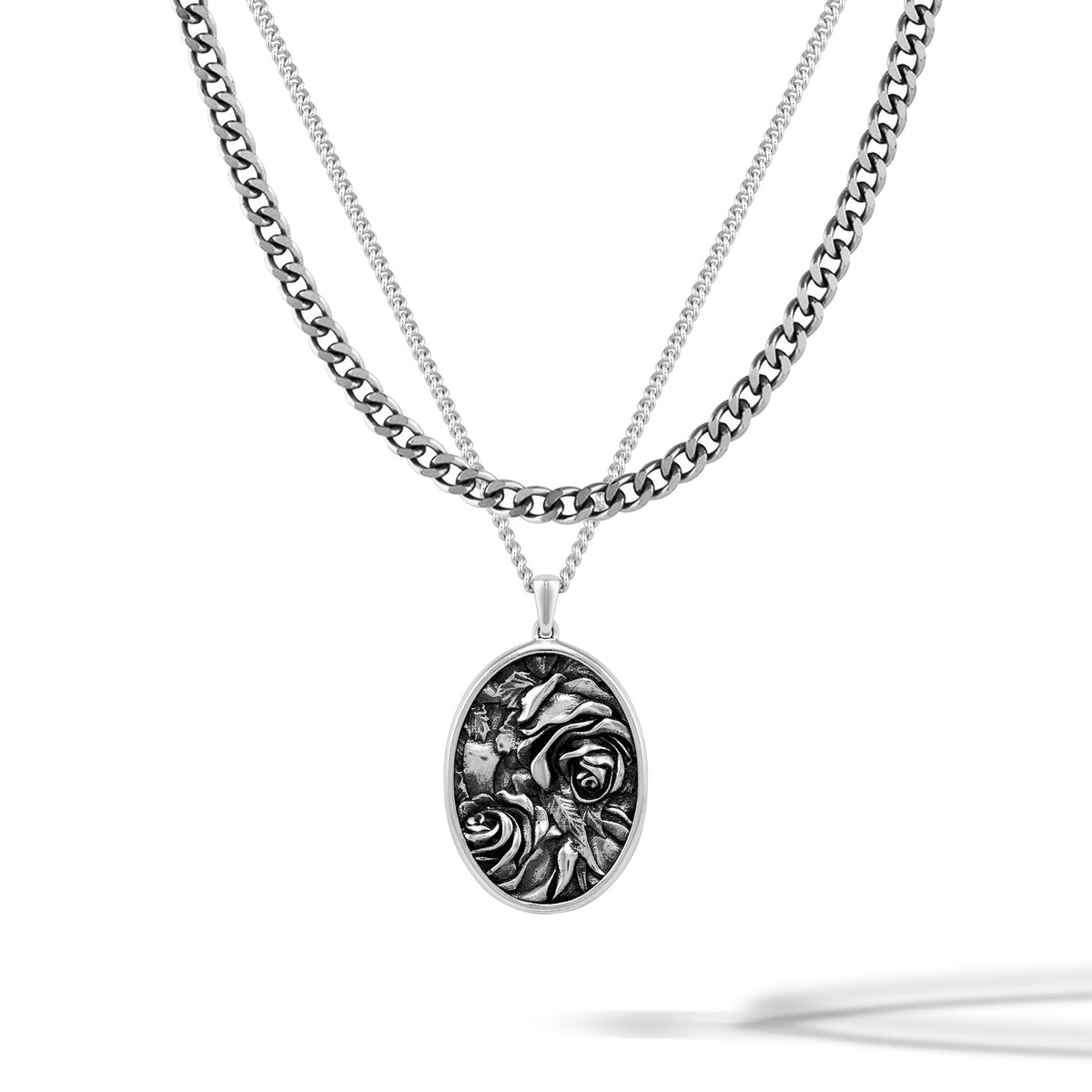 Silver necklace with a detailed pendant on a white background