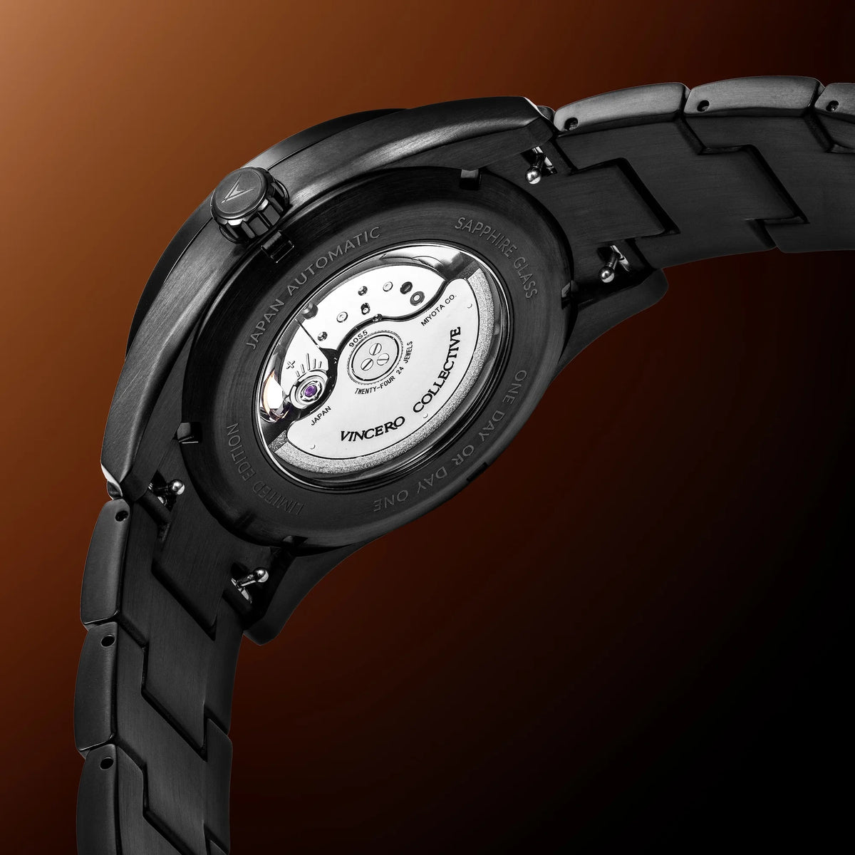 Close-up of a black wristwatch with visible brand name on a brown background