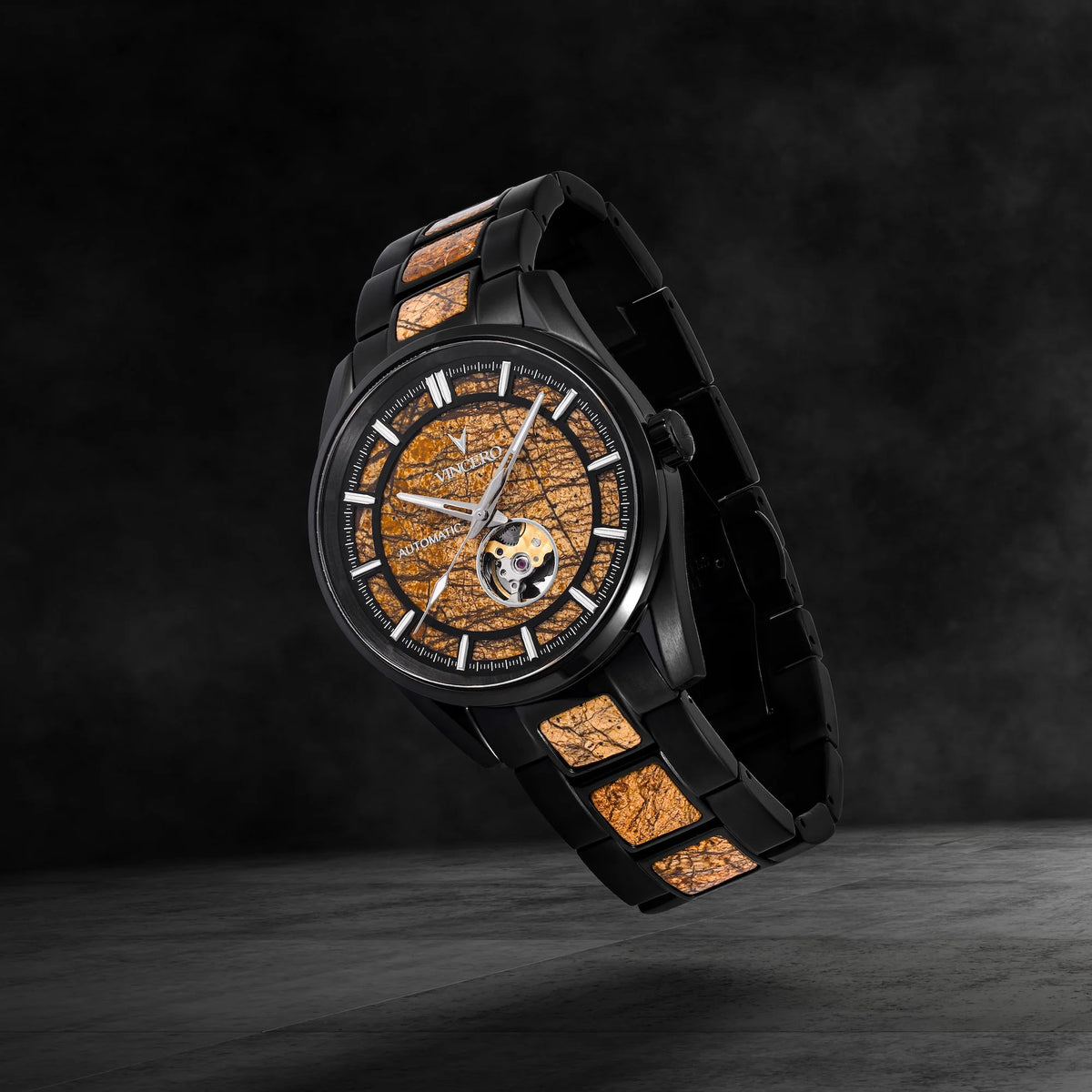 Luxury watch with black strap and detailed face on a dark background