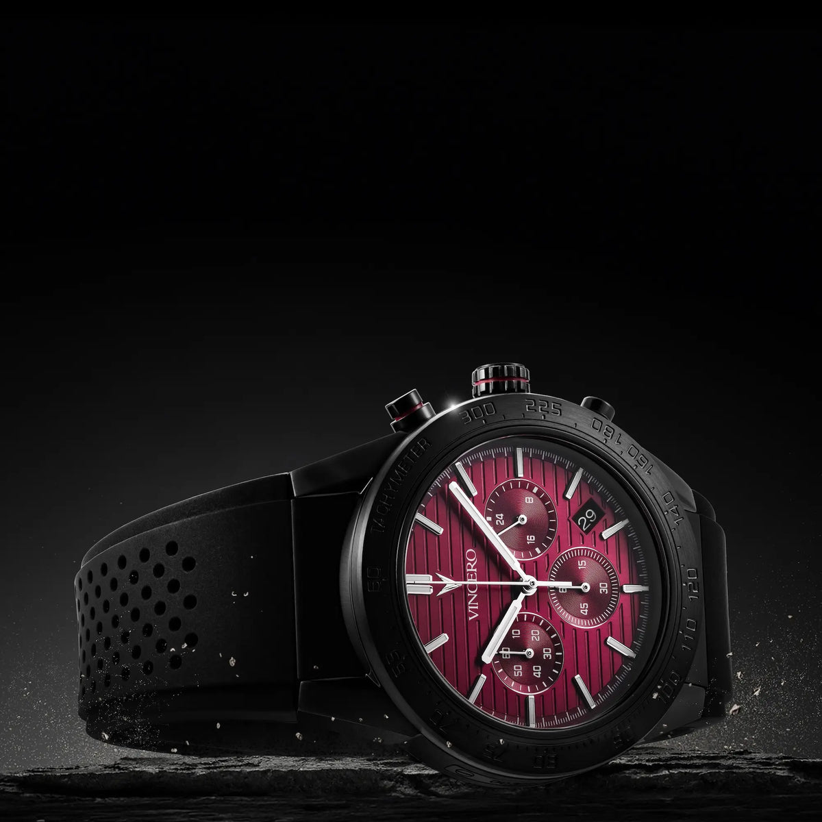 Watch with a red face and black strap on a dark background