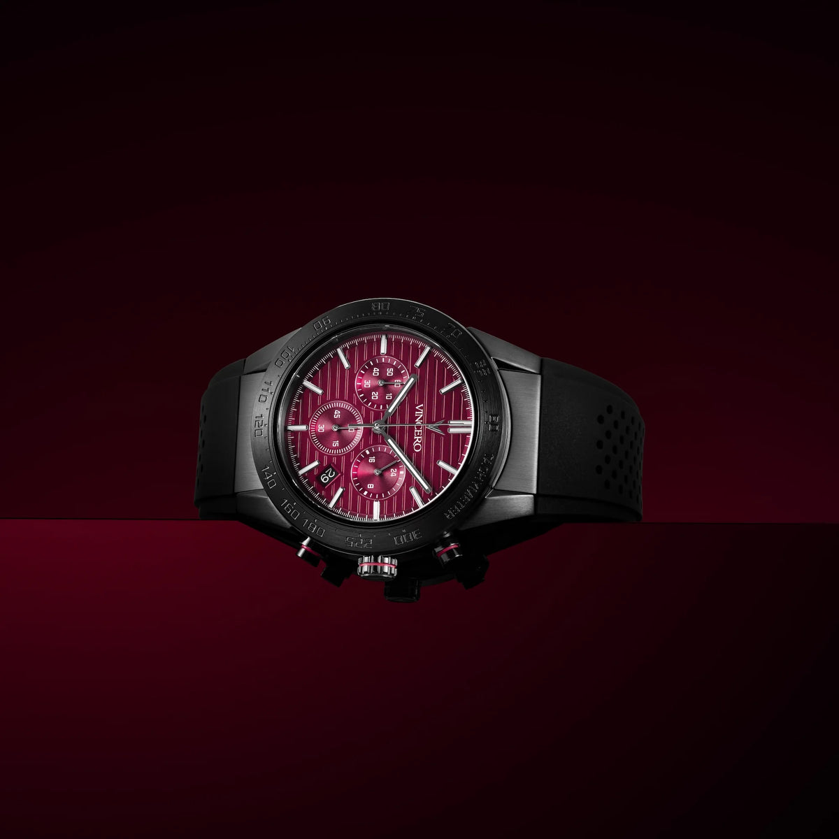 Black watch with a red face on a dark red background