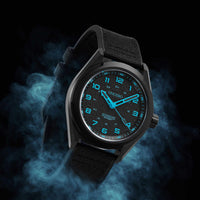Black wristwatch with blue glowing face on a dark background