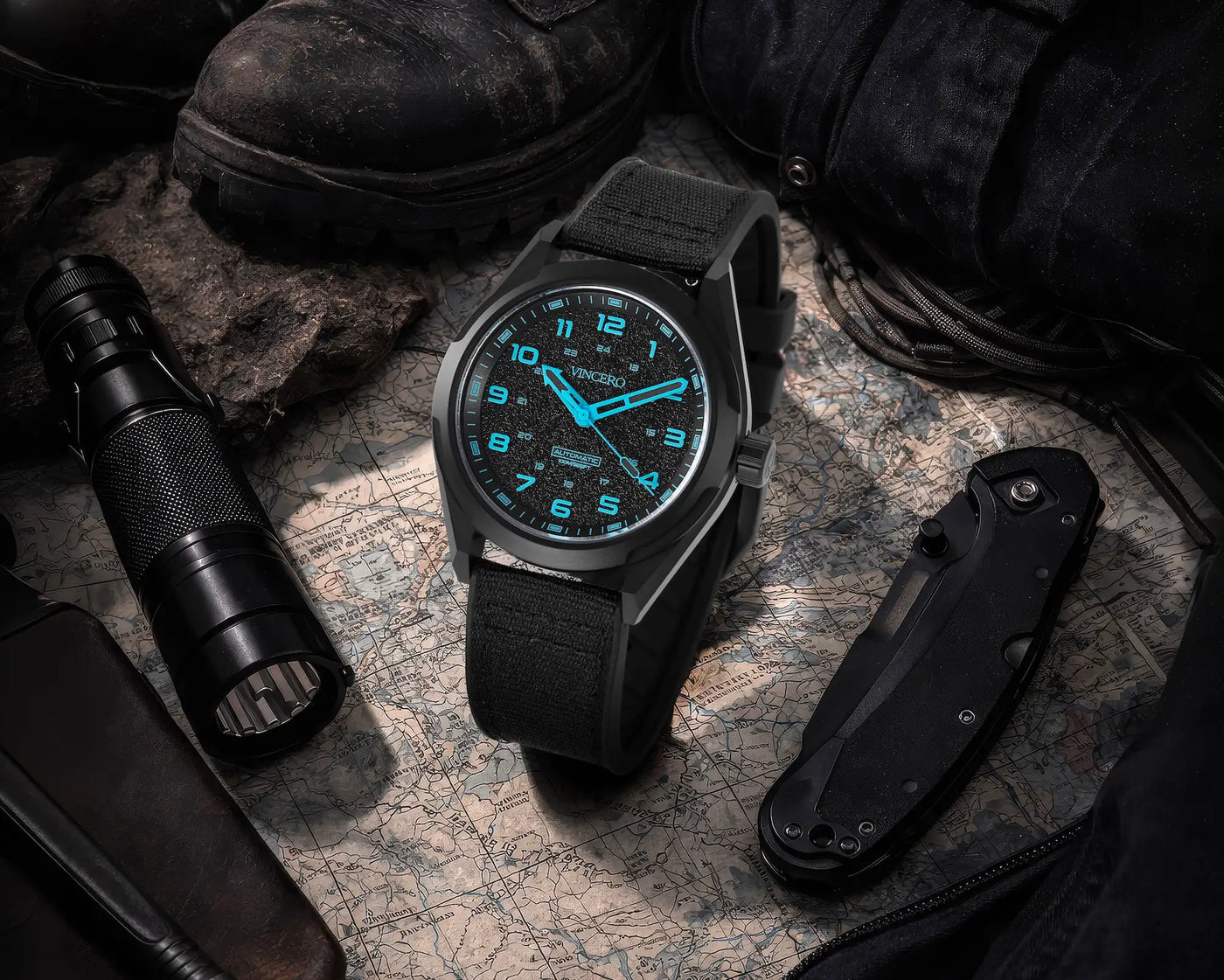 Black watch with blue digital display on a map with tactical items around