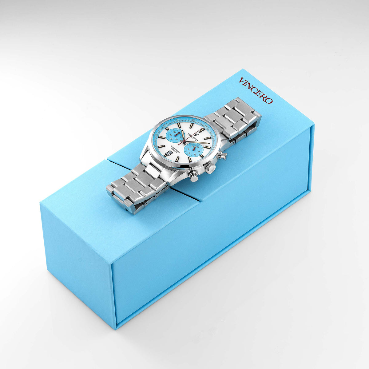 Silver watch with blue accents on a blue box, featuring the brand 'Vincero'.