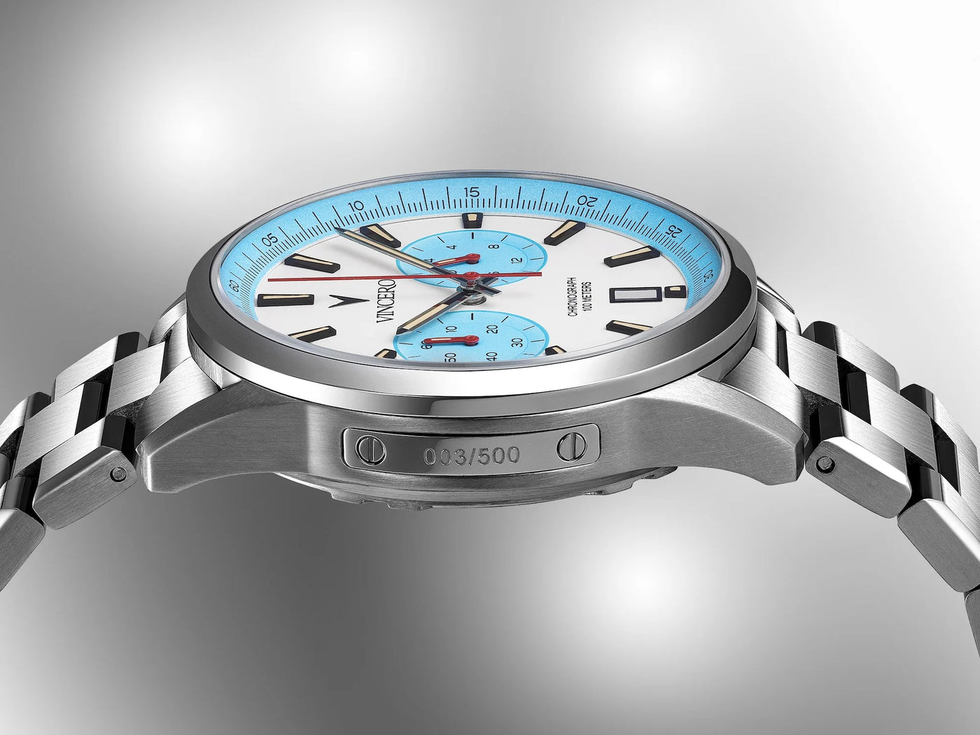 Silver watch with a blue and white face on a gray background