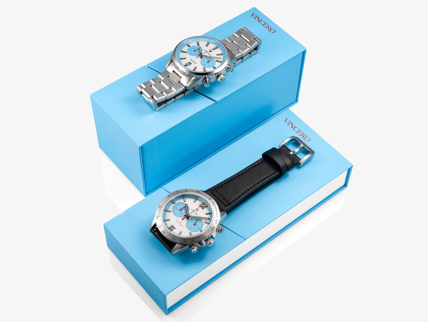 Two watches with different straps on blue display stands