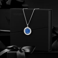 Silver necklace with a blue pendant on a black box with 'Vincero' branding.