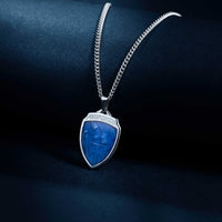 Silver necklace with a blue stone pendant on a dark background