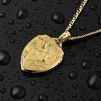 Gold necklace with a detailed pendant on a black surface with water droplets