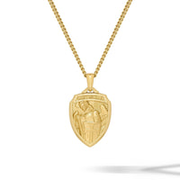 Gold necklace with a shield-shaped pendant on a white background