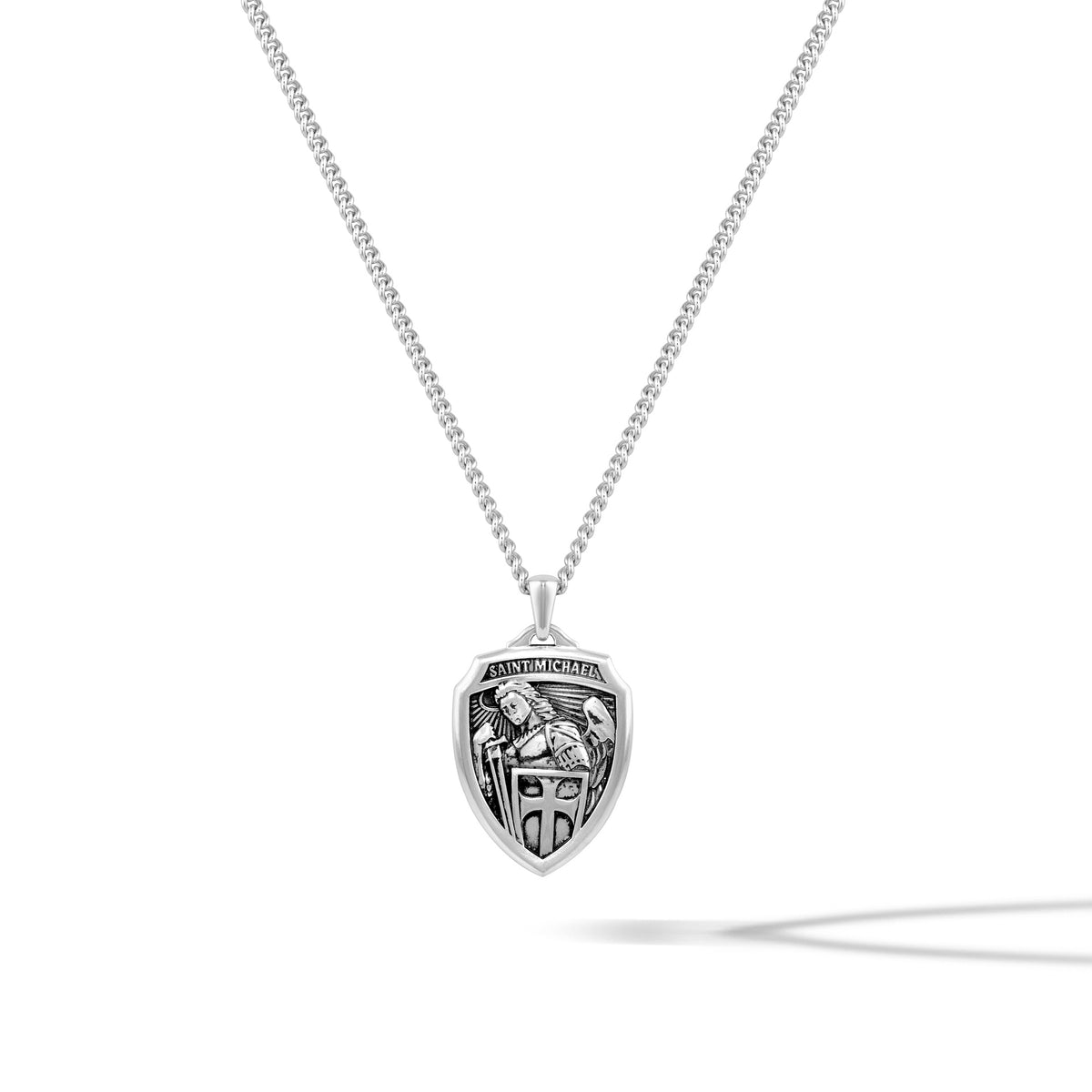 Silver necklace with a shield-shaped pendant on a white background