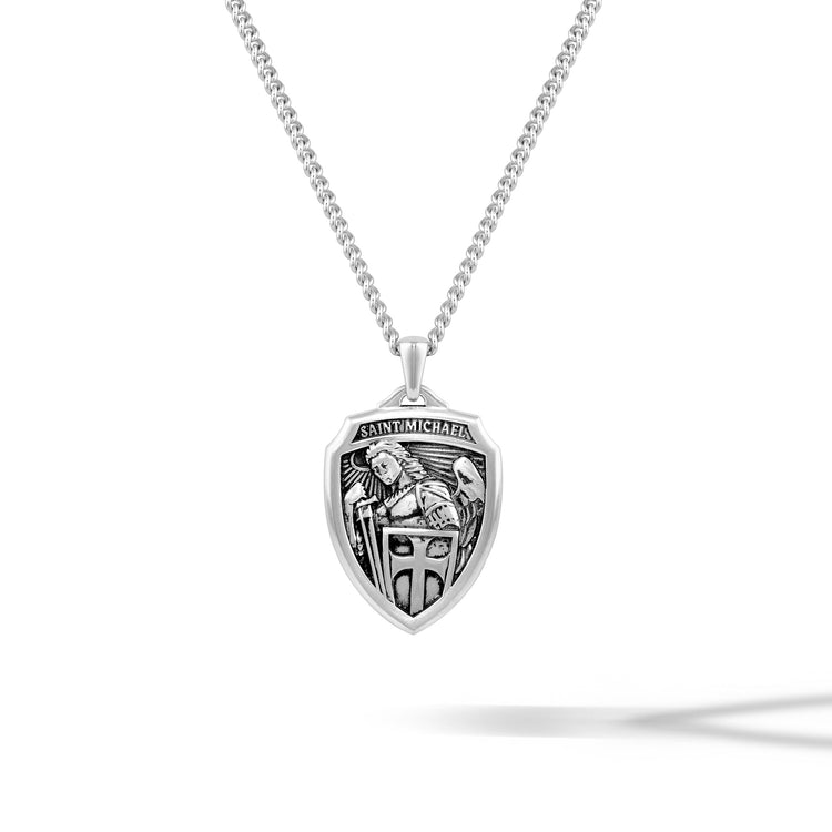 Silver pendant necklace with 'Saint Michael' design on a white background