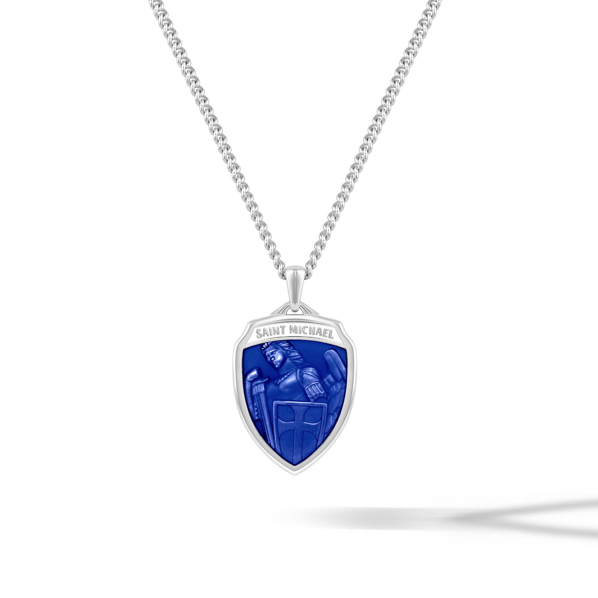 Shield-shaped pendant with blue center and 'Saint Michael' engraving on a white background