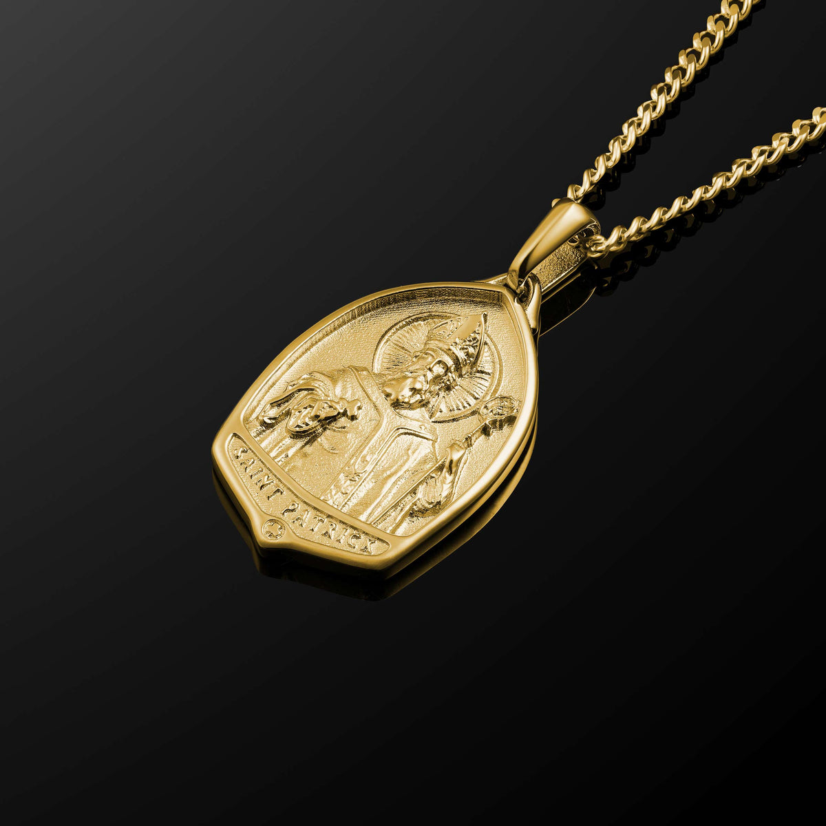 Gold necklace with a pendant on a black background