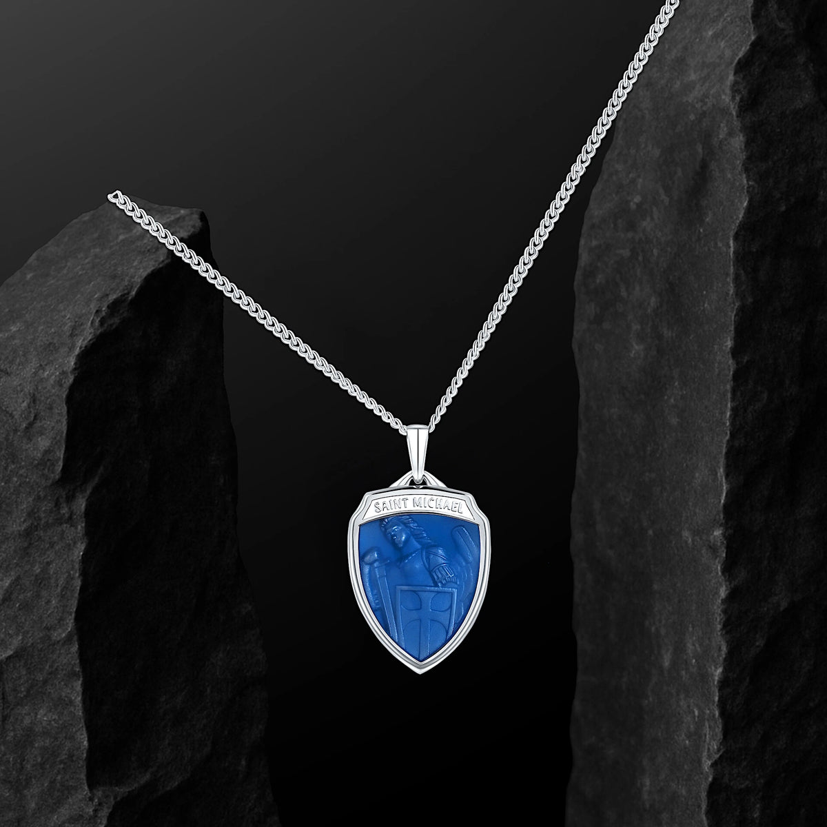 Silver necklace with a blue pendant on a dark background
