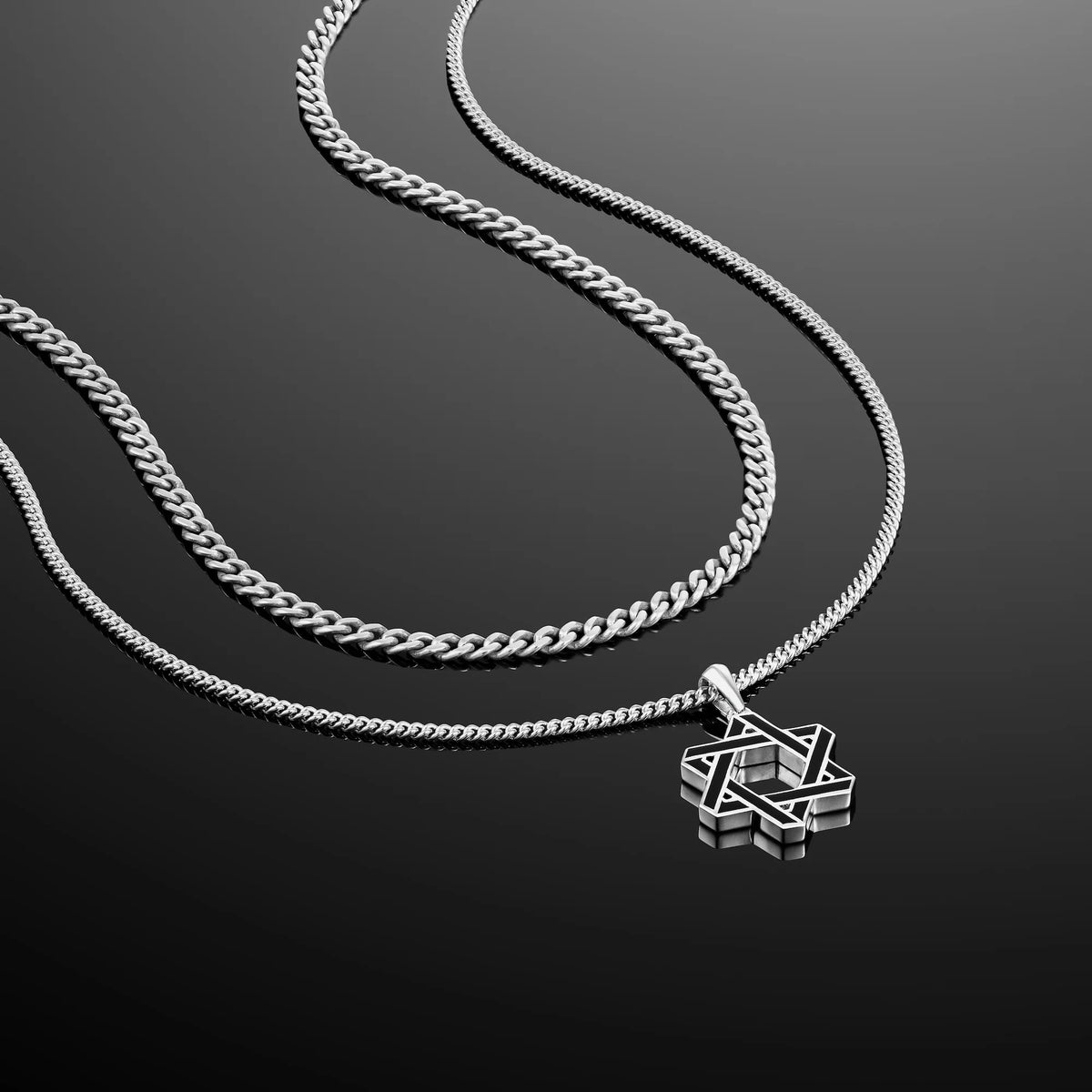 A sterling silver Star of David pendant necklace on a double curb chain.