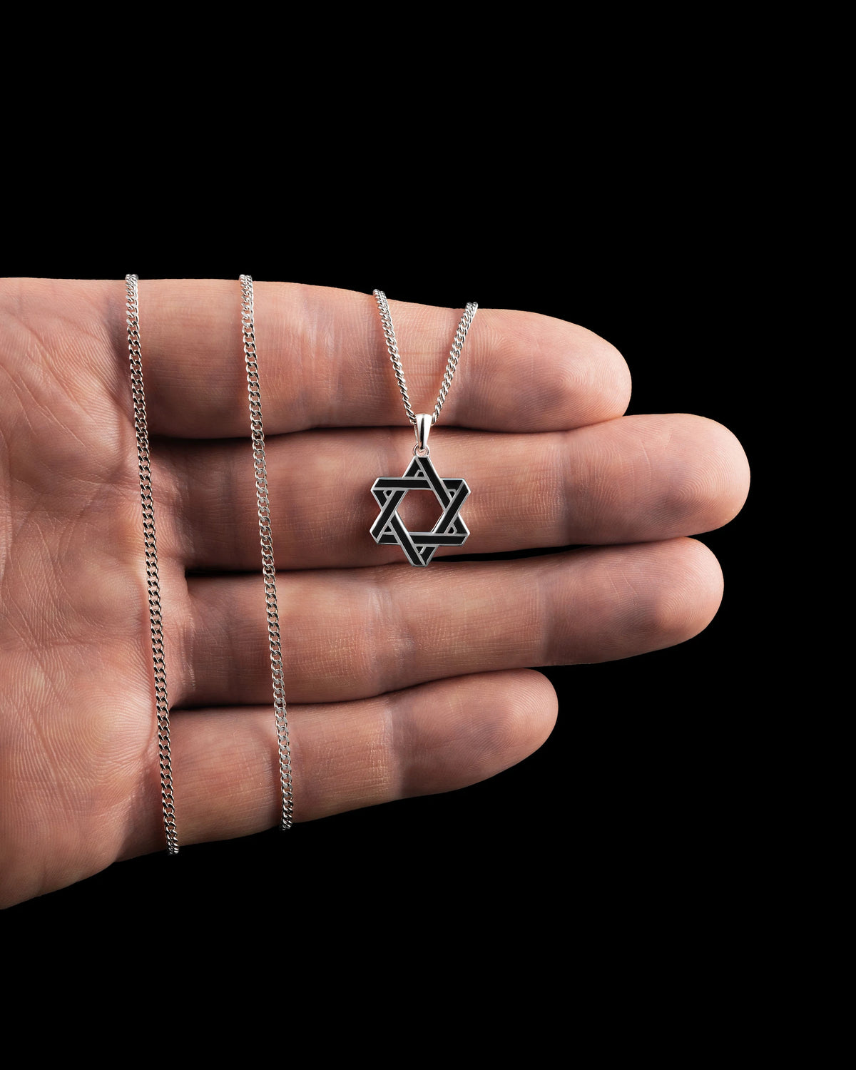 A sterling silver Star of David pendant necklace on a double curb chain.
