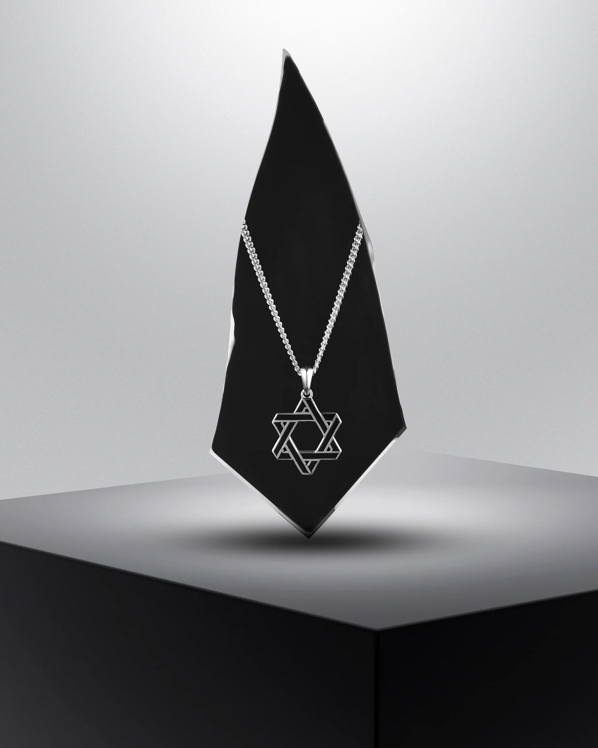 A sterling silver Star of David pendant necklace on a double curb chain.