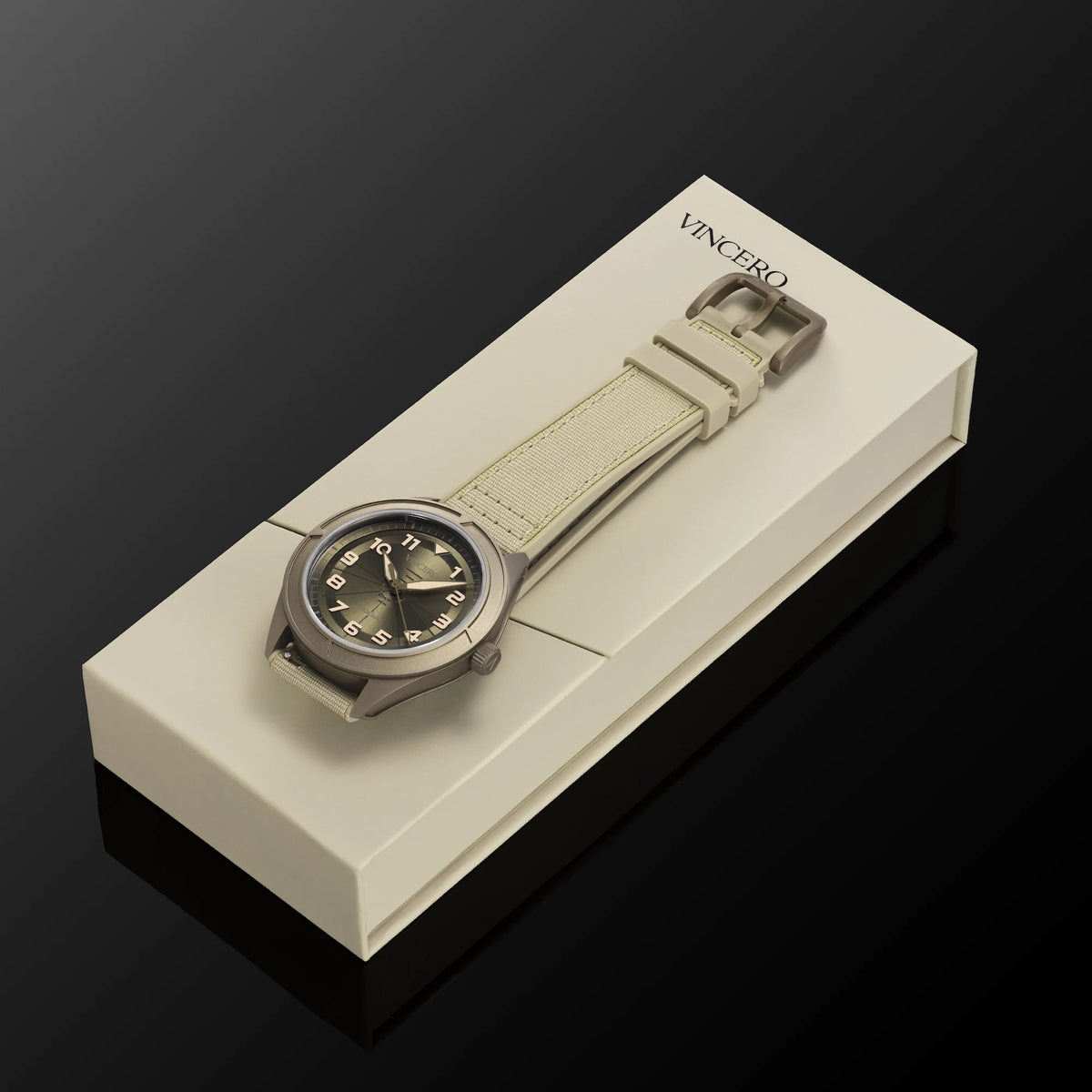 Watch with beige strap in a white box on a black background, featuring the brand 'Vincent'.