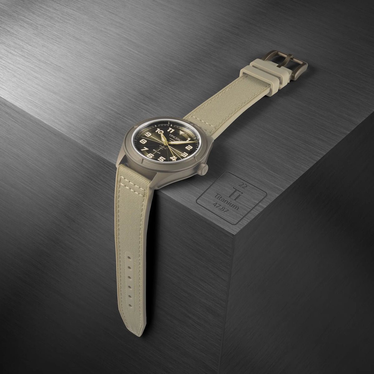 Watch with beige strap on a textured dark surface