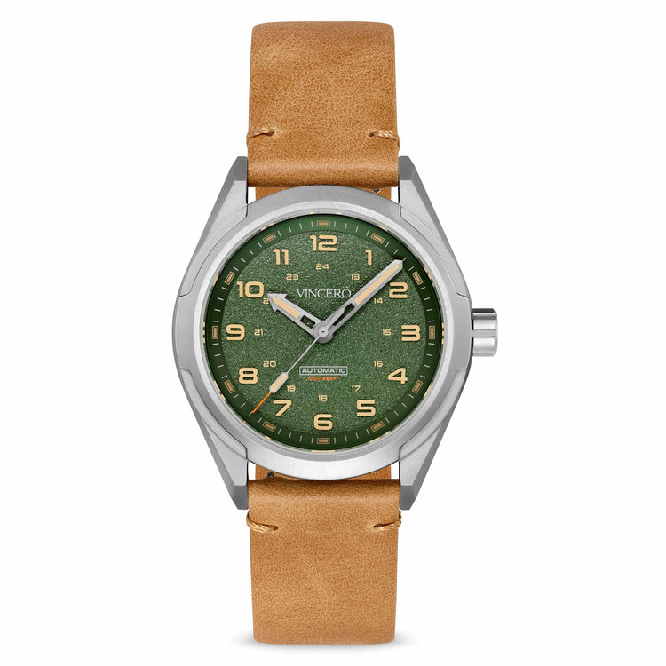 A silver-toned titanium watch with a green dial and a tan leather strap.