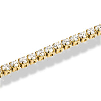 Gold bracelet with clear gemstones on a white background