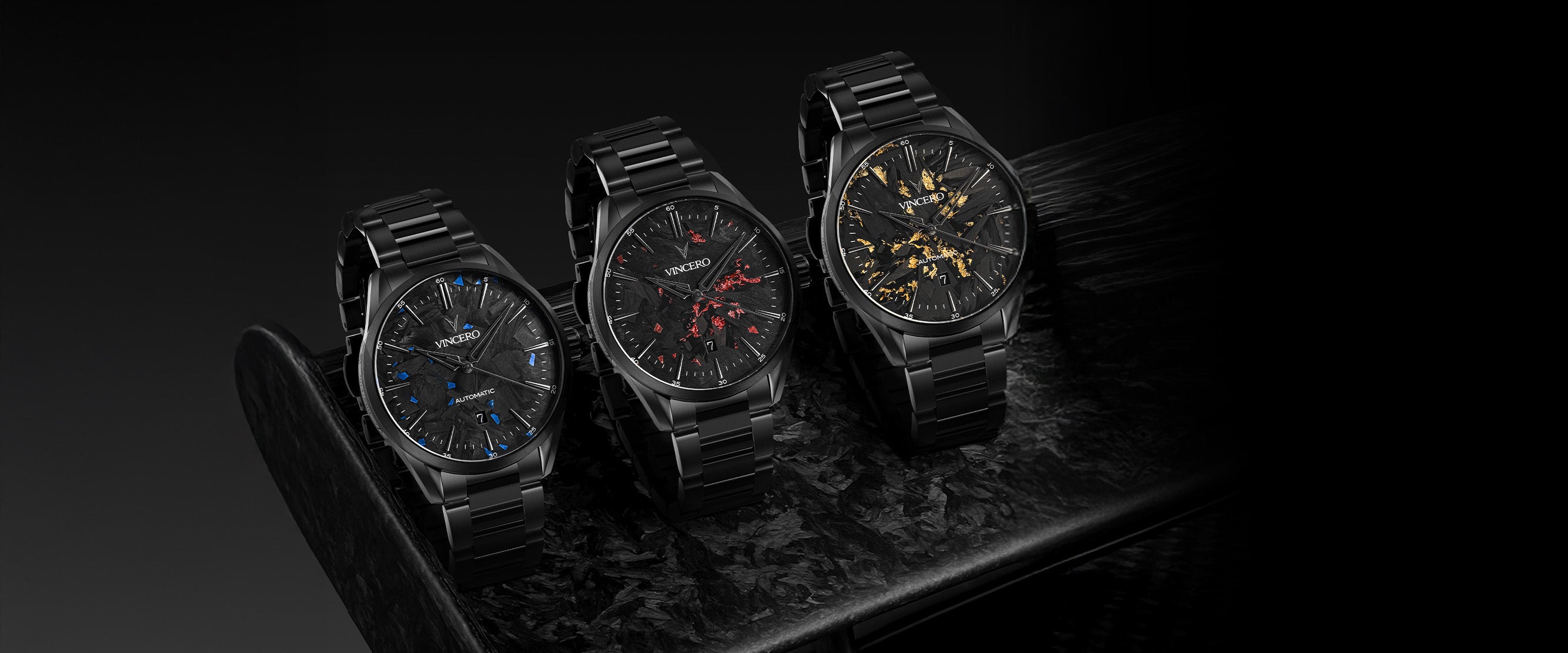 Three black watches on a dark surface with a black background
