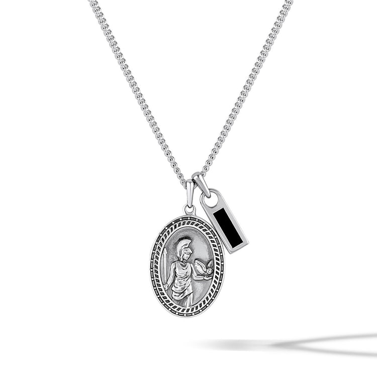 Silver necklace with two pendants on a white background
