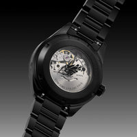 Black wristwatch with visible mechanical components on a dark background