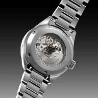 Silver watch with visible mechanical components on a dark background