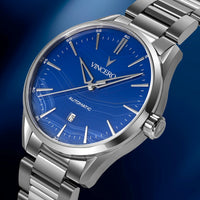 Silver watch with blue dial on a dark blue background