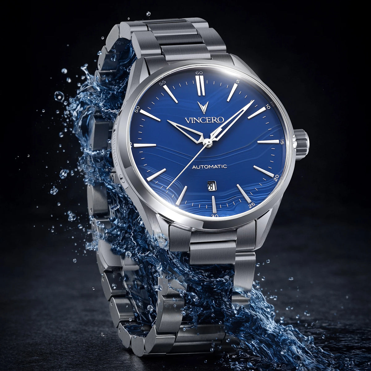 Silver Vincero watch with blue dial surrounded by water on a dark background