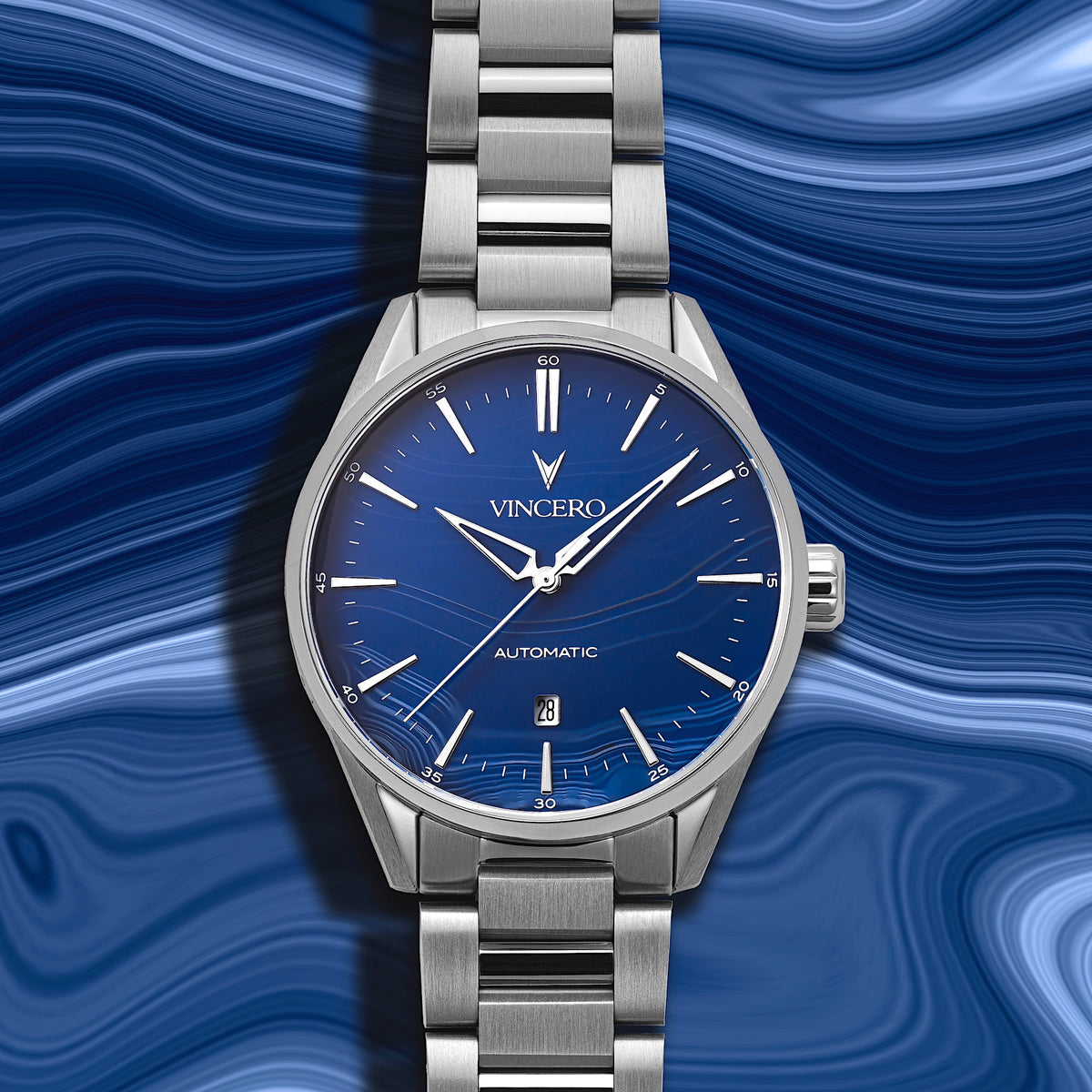 Silver wristwatch with blue dial on a blue wavy background
