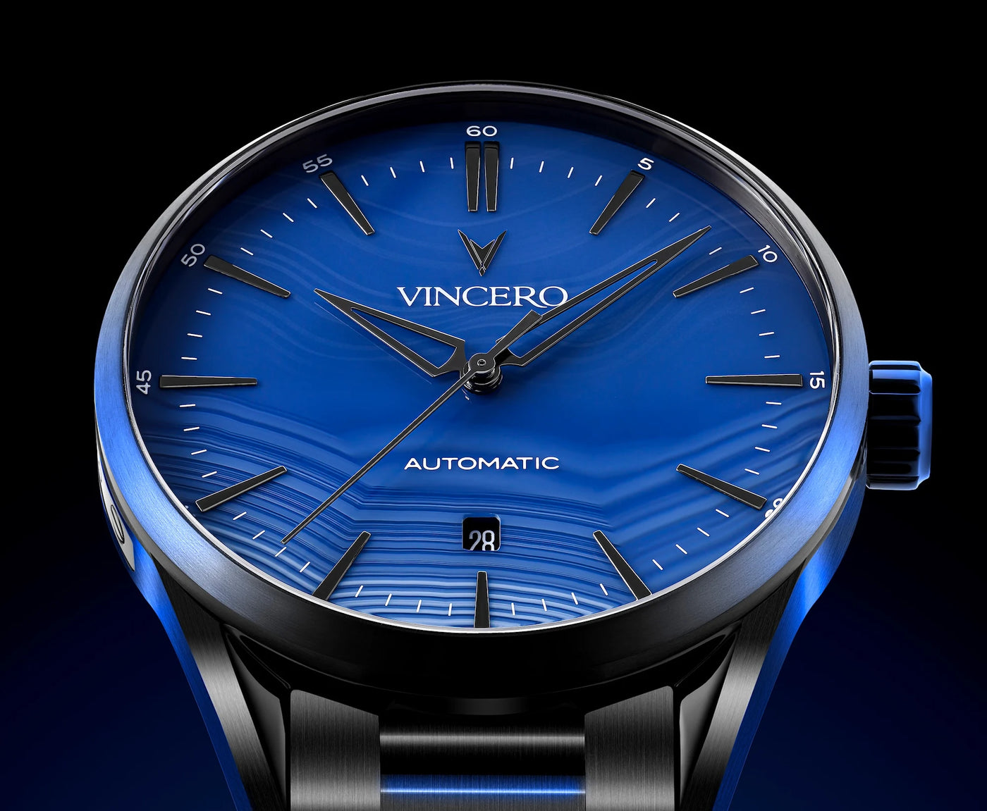 Vincero watch with blue face and black strap on a dark background