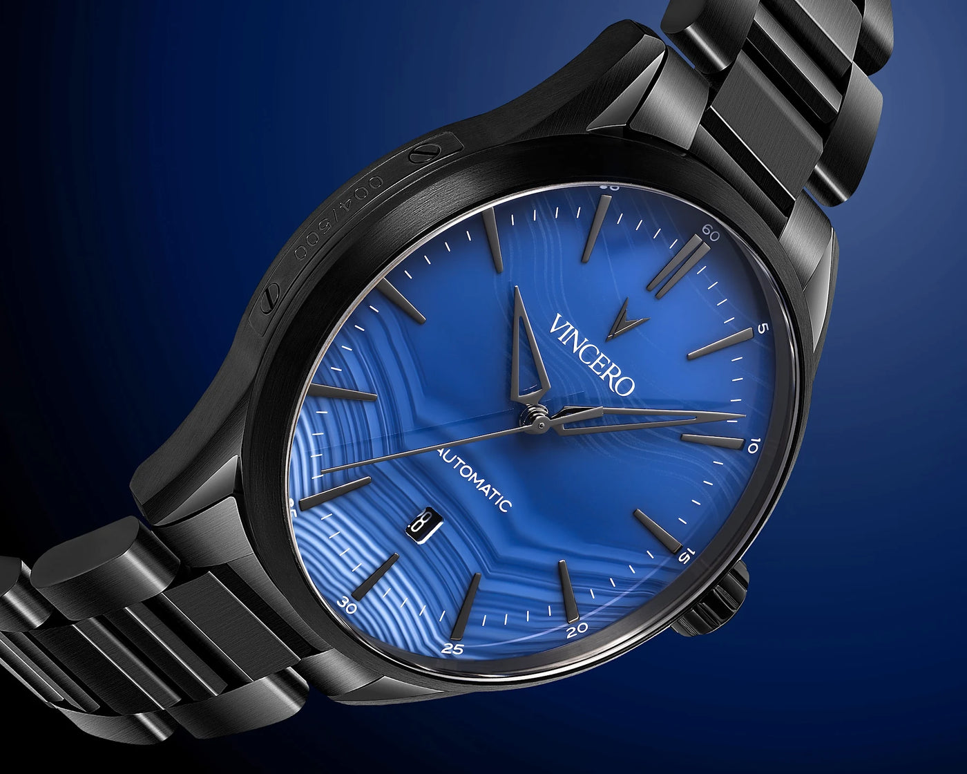 Black wristwatch with blue dial on a dark blue background, featuring the brand 'Vincero'.