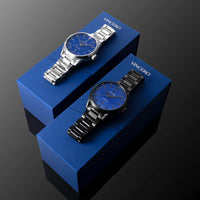 Two watches on blue Vincero boxes against a dark background